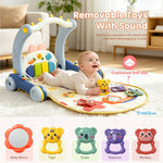 A baby lies on a colorful activity play mat in a bright living room. The mat has an arch with toys and text overlays reading 'Removable Toys With Sound' and 'Cushioned Soft Mat.