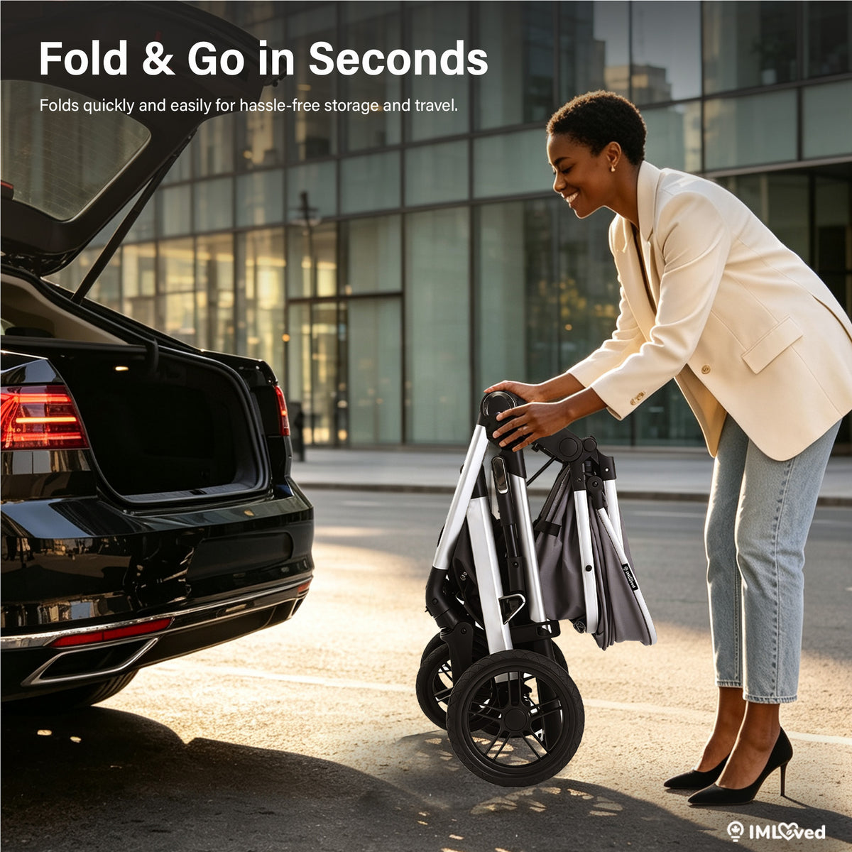 A woman in a cream blazer and light blue jeans is folding a compact rolling suitcase with a telescoping handle and black wheels next to an open black car trunk in an outdoor urban setting. Text at the top reads 'Fold & Go in Seconds' and a small 'IMLSved' logo appears in the bottom right corner.